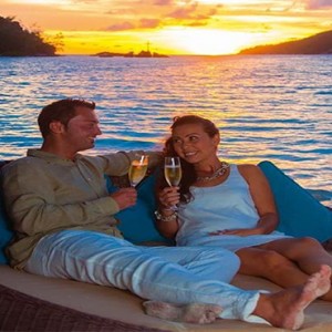 Constance Ephelia - Luxury Seychelles Honeymoon Packages - Couple enjoying champagne