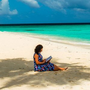 Maldives Honeymoon Packages Constance Halaveli Resort Woman Reading On Beach