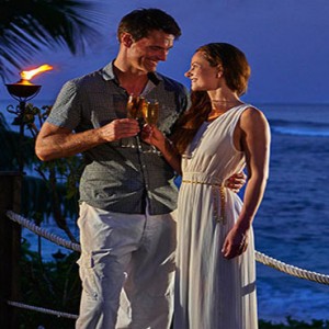 Hilton Seychelles Labriz Resort & Spa - Luxury Seychelles Honeymoon Packages - Couple enjoying a drink at night