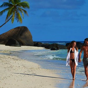 Hilton Seychelles Labriz Resort & Spa - Luxury Seychelles Honeymoon Packages - Couple romantic stroll on beach