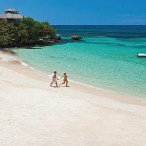 Jamaica Honeymoon Packages Sandals Ochi Beach Resort Couple Walking On Beach