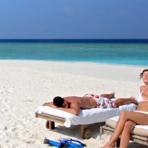 Maldives Honeymoon Packages Six Senses Laamu Couple Sunbathing On Sandbank