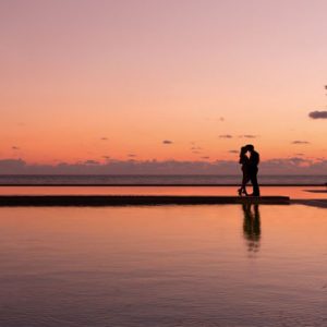 Mexico Honeymoon Packages Secrets Playa Mujeres Couple By Pool At Sunset