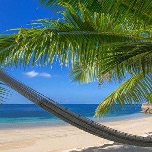 Coco de Mer & Black Parrot Suites - Luxury Seychelles Honeymoon Packages - hammock on beach