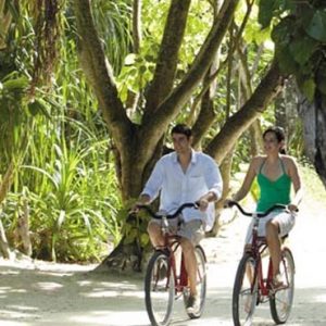 Maldives Honeymoon Packages Shangri La’s Villingili Resort And Spa Couple Cycling Around The Resort