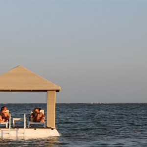 Puri Santrian - Bali Honeymoon Packages - relaxing in cabana on sea