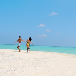 Couple on beach - Kanuhura Maldives - Luxury Maldives Honeymoons