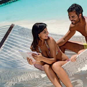 couple on hammock - Kanuhura Maldives - Luxury Maldives Honeymoons