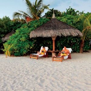 couple on the beach - Kanuhura Maldives - Luxury Maldives Honeymoons