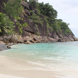 Four Seasons Resort Seychelles - Luxury Seychelles Honeymoon packages - man strolling on beach