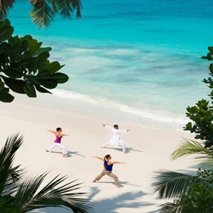 Four Seasons Resort Seychelles - Luxury Seychelles Honeymoon packages - yoga on beach