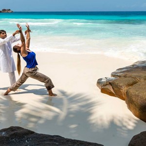 Four Seasons Resort Seychelles - Luxury Seychelles Honeymoon packages - yoga on beach1