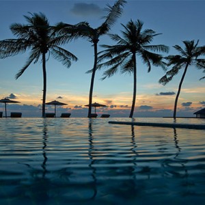 Loama Resort Maldives at Maamigili - Luxury Maldives Honeymoon packages - infinity pool at dusk