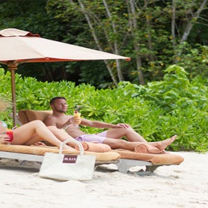 MAIA Luxury Resort and Spa - Luxury Seychelles Honeymoon Packages - couple on the beach