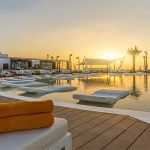 Nikki Beach Resort and Spa - Luxury Dubai Honeymoon Packages - pool at sunset