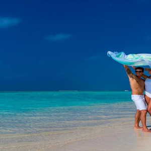 Cocoon Maldives - Luxury Maldives Honeymoon Packages - couple at beach