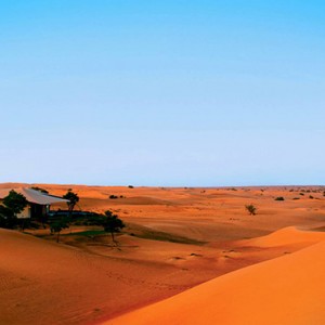 Al Maha Resort and Spa - Luxury Dubai Honeymoon Packages - Couple on sand dune
