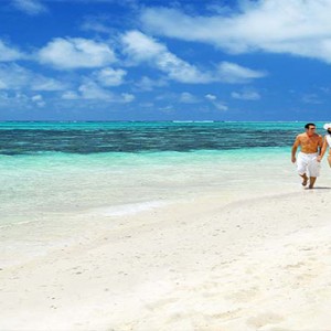 Astroea beach - Luxury Mauritius Honeymoon Packages - Couple walking on beach