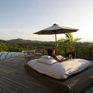 Le Domaine de L'Orangeraie - Luxury seychelles honeymoon packages - woman relaxing by pool