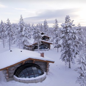Kakslauttanen Arctic Resort - Luxury Finland Honeymoon Packages - Kelo Glass igloos exterior in snow