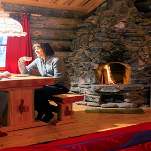 Kakslauttanen Arctic Resort - Luxury Finland Honeymoon Packages - Log Cabins couple talking