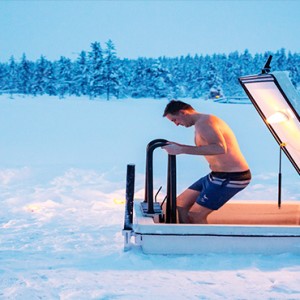 Kakslauttanen Arctic Resort - Luxury Finland Honeymoon Packages - ice swimming1