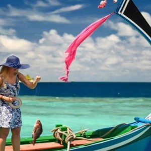 Coco Bodu Hithi - Luxury Maldives Honeymoon Packages - Catching fish