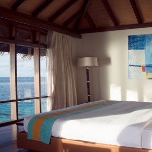 Coco Bodu Hithi - Luxury Maldives Honeymoon Packages - Escape Water Villa bedroom