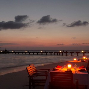 Coco Bodu Hithi - Luxury Maldives Honeymoon Packages - Private dining at night