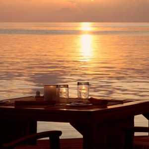 Coco Bodu Hithi - Luxury Maldives Honeymoon Packages - dining at sunset