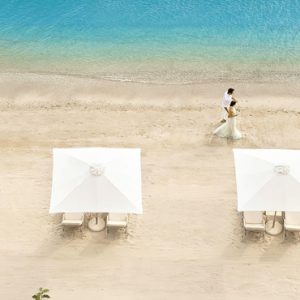 Couple Strolling On Beach Ikos Olivia Resort Greece Honeymoons