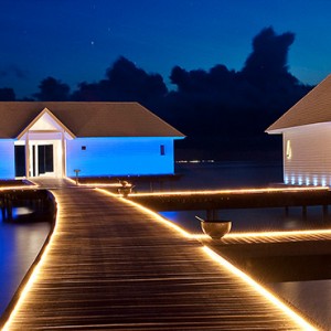 Diamonds Athuruga - Luxury Maldives Honeymoon Packages - Two Bedroom Water Villa exterior at night