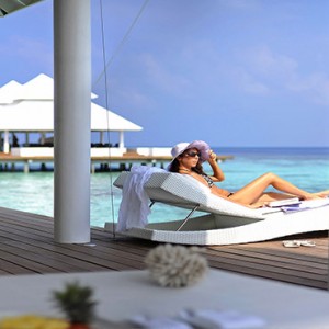 Diamonds Athuruga - Luxury Maldives Honeymoon Packages - women relaxing on villa deck