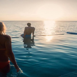 Hurawalhi Island - Luxury Maldives Honeymoon Packages - Couple in pool