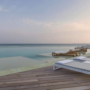 Hurawalhi Island - Luxury Maldives Honeymoon Packages - sun loungers by pool