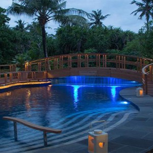 JA Manafaru - Luxury Maldives honeymoon packages - Andiamo Bistro and Pool outdoors at night