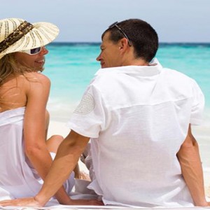 JA Manafaru - Luxury Maldives honeymoon packages - Couple on the beach