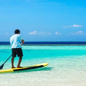 Lily Beach Resort and Spa at Huvahendhoo - Luxury Maldives Honeymoon Packages - Beach Villa paddle boarding