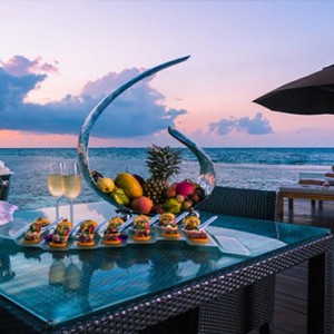 Lily Beach Resort and Spa at Huvahendhoo - Luxury Maldives Honeymoon Packages - Deluxe Water Villa dining on deck