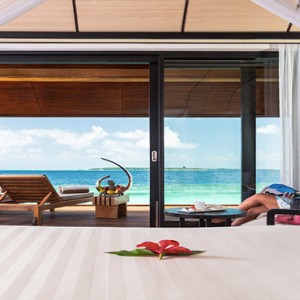 Lily Beach Resort and Spa at Huvahendhoo - Luxury Maldives Honeymoon Packages - Lagoon Villa women relaxing in resort