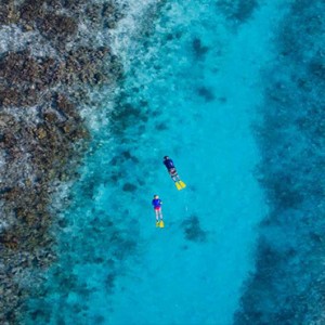 Lily Beach Resort and Spa at Huvahendhoo - Luxury Maldives Honeymoon Packages - Snorkelling in reef