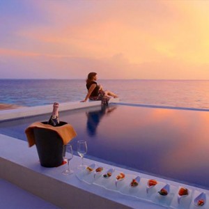 Lily Beach Resort and Spa at Huvahendhoo - Luxury Maldives Honeymoon Packages - pool view at sunset