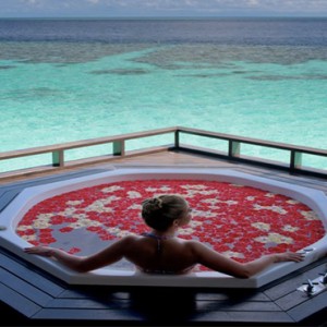 Lily Beach Resort and Spa at Huvahendhoo - Luxury Maldives Honeymoon Packages - woman in spa jacuzzi