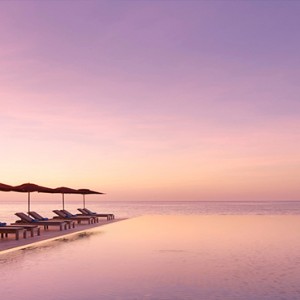 Lux South Ari Atoll - Luxury Maldives Honeymoon Packages - Main pool at sunset