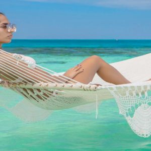 Maldives Honeymoon Packages Sun Siyam Vilu Reef Women On Hammock