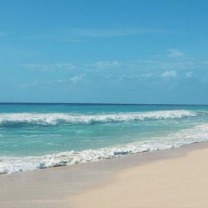 Mexico Honeymoon Packages Secrets The Vine Cancun Couple Walking On Beach