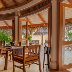 Milaidhoo Island Maldives - Luxury Maldives Honeymoon Packages - The Shoreline Grill interior dining at night