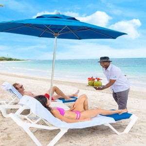 Serenity at Coconut Bay - Luxury St lucia Honeymoon Packages - Couple relaxing on beach