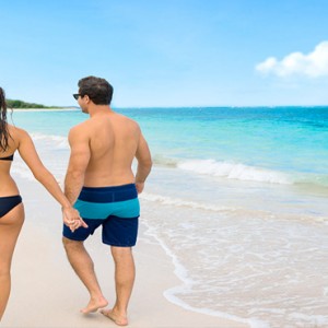 Serenity at Coconut Bay - Luxury St lucia Honeymoon Packages - Couple walking on beach