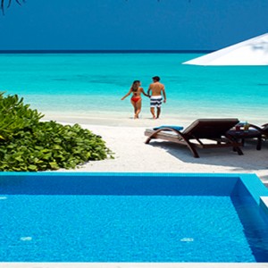 Velassaru Maldives - Luxury Maldives Honeymoon Packages - Beach Villa with pool couple on beach